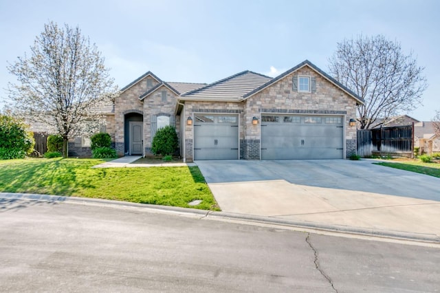 view of front of home featuring a garage, driveway, and a front lawn