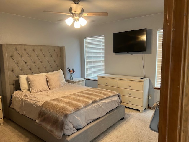 bedroom with light carpet and ceiling fan