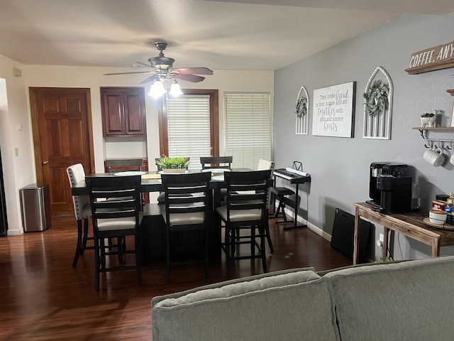 dining room with dark wood finished floors, baseboards, and ceiling fan