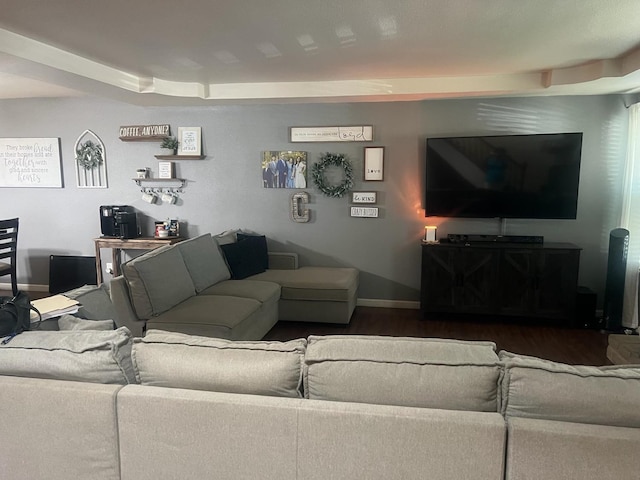 living room featuring baseboards and wood finished floors