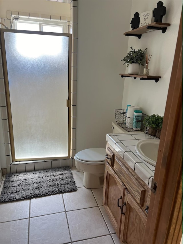 full bathroom featuring tile patterned floors, a shower stall, toilet, and vanity