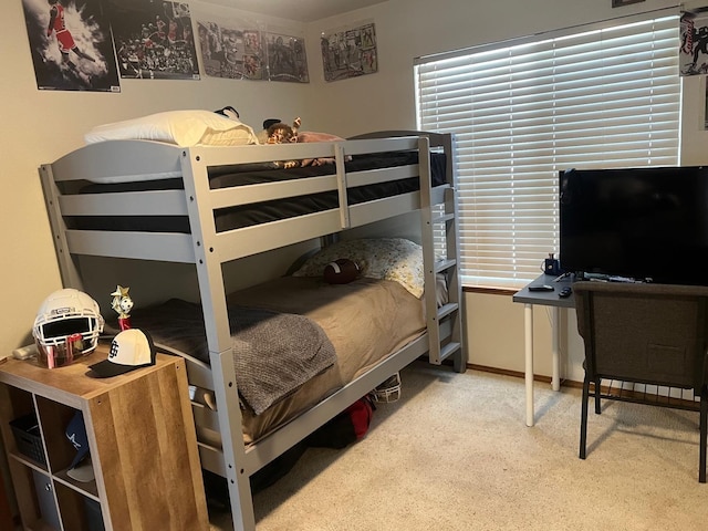 bedroom featuring baseboards and carpet