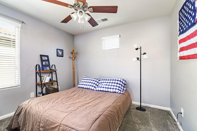 bedroom featuring multiple windows, carpet flooring, baseboards, and visible vents