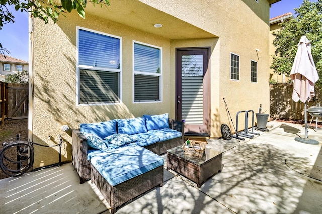 view of patio featuring an outdoor hangout area and fence