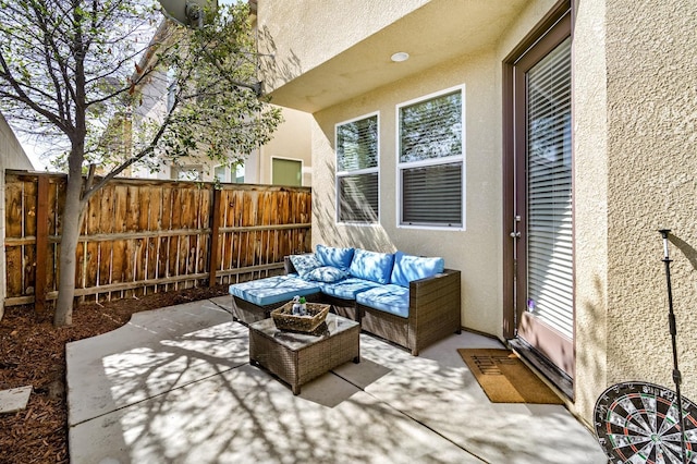 view of patio featuring an outdoor hangout area and fence