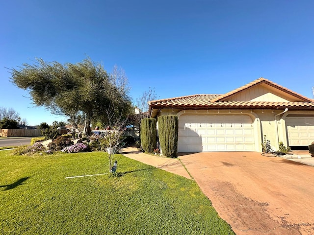 view of front of property featuring stucco siding, concrete driveway, a front lawn, and a tile roof