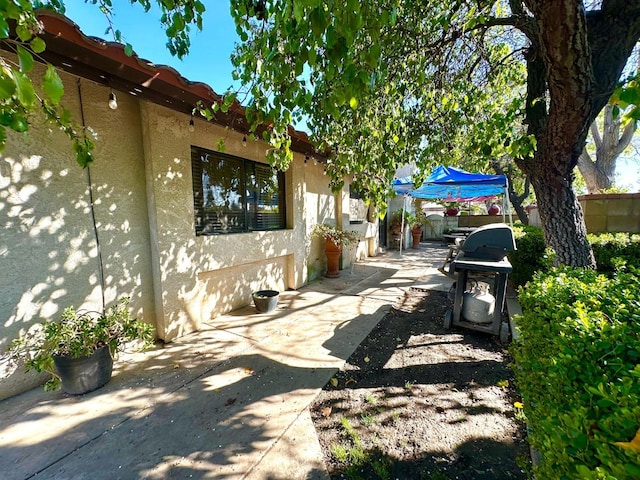 view of patio / terrace with a grill and fence