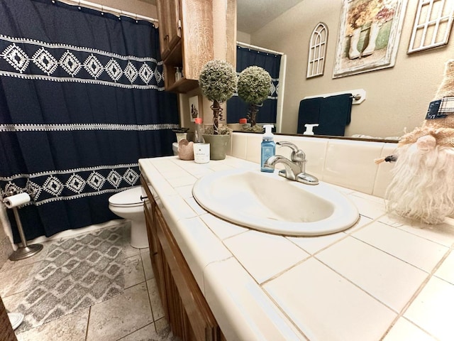 bathroom featuring vanity, toilet, and a shower with curtain