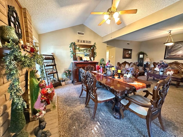 dining area featuring vaulted ceiling, a ceiling fan, visible vents, and a textured ceiling