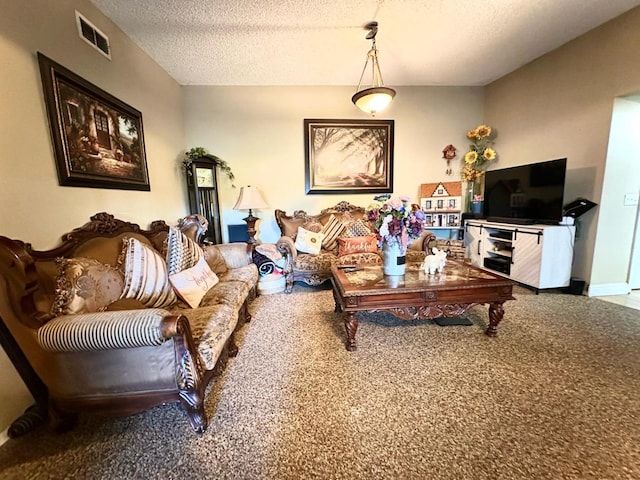 living area featuring visible vents, a textured ceiling, and carpet floors