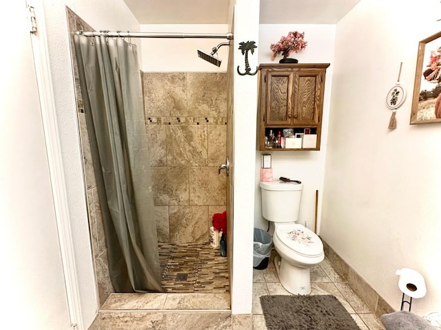 full bathroom with baseboards, toilet, a stall shower, and tile patterned flooring