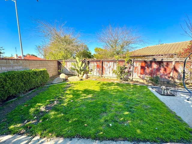 view of yard with a fenced backyard