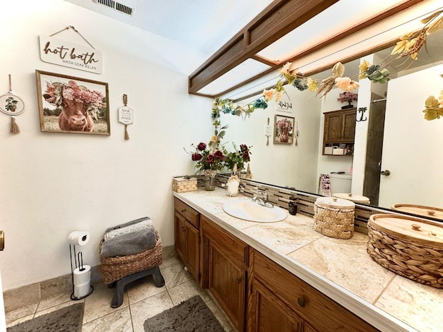 bathroom with vanity and visible vents