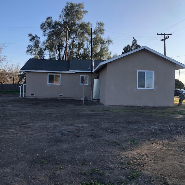 back of house featuring stucco siding