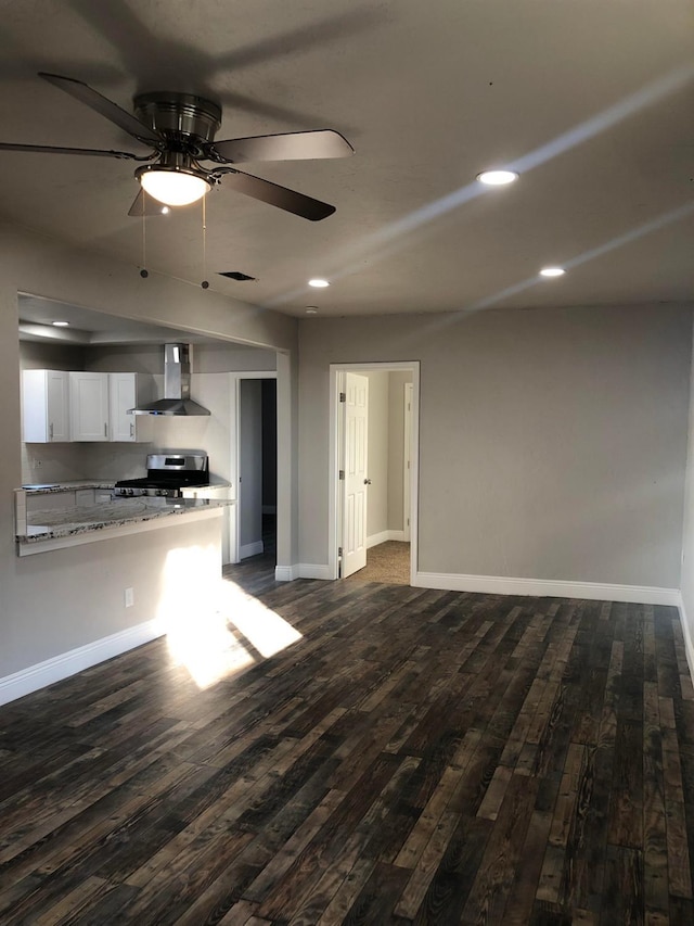 unfurnished living room with dark wood finished floors, recessed lighting, and baseboards