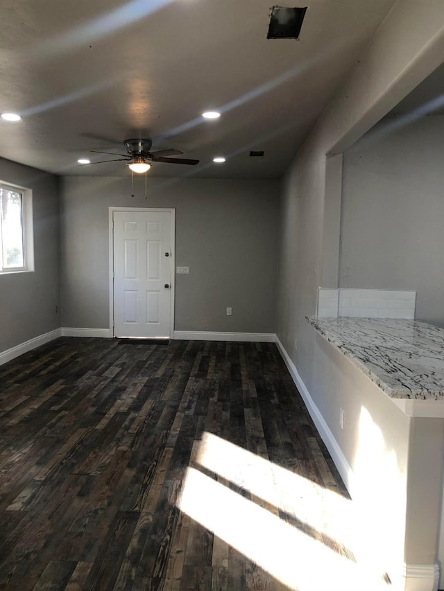 unfurnished room with dark wood finished floors, recessed lighting, baseboards, and ceiling fan