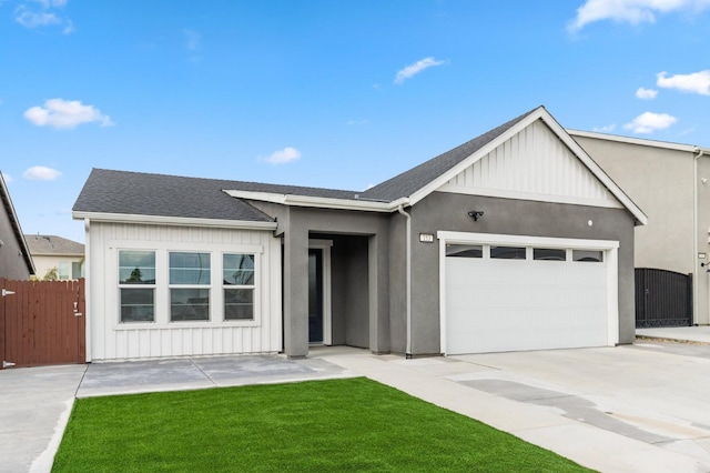 view of front facade featuring driveway, fence, roof with shingles, board and batten siding, and an attached garage