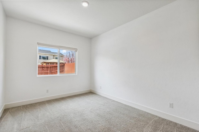 unfurnished room featuring baseboards and carpet