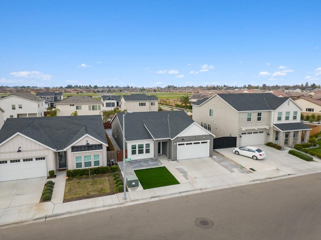 view of front of house featuring a residential view, driveway, board and batten siding, and fence