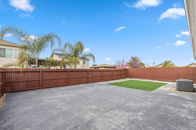 view of patio featuring central air condition unit and a fenced backyard