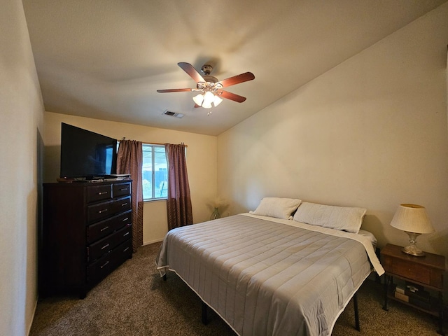 bedroom featuring visible vents, dark colored carpet, and ceiling fan