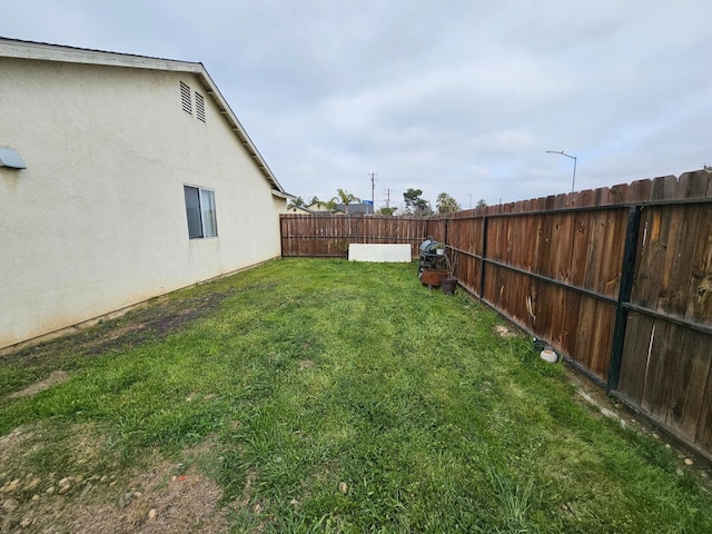 view of yard with a fenced backyard