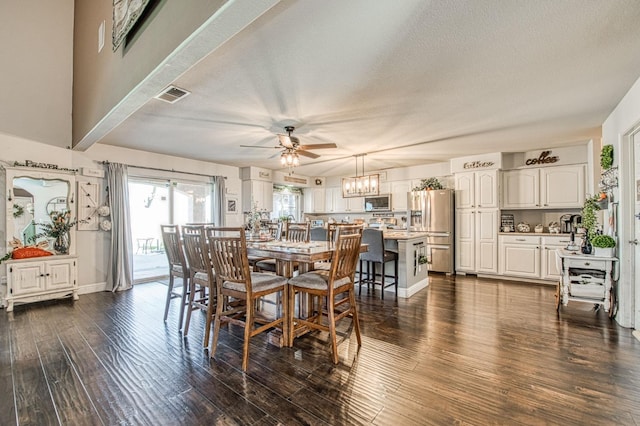 dining room featuring visible vents, baseboards, ceiling fan with notable chandelier, a textured ceiling, and dark wood-style flooring