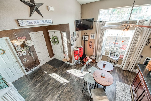 foyer with dark wood finished floors and baseboards