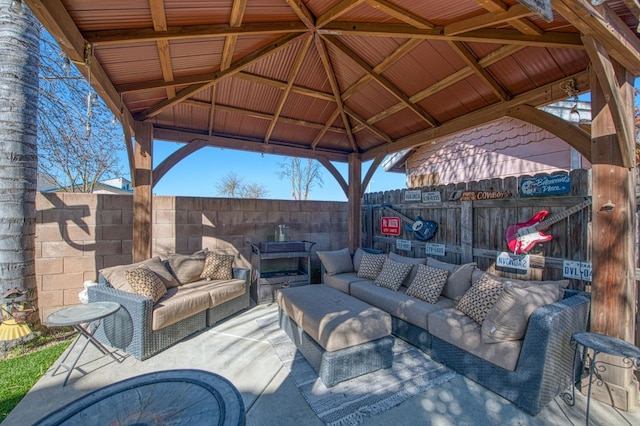 view of patio / terrace featuring a gazebo, a fenced backyard, and an outdoor living space