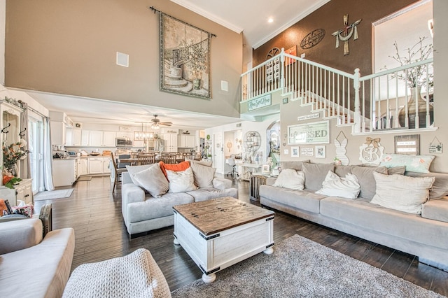 living area featuring visible vents, wood finished floors, a ceiling fan, and ornamental molding