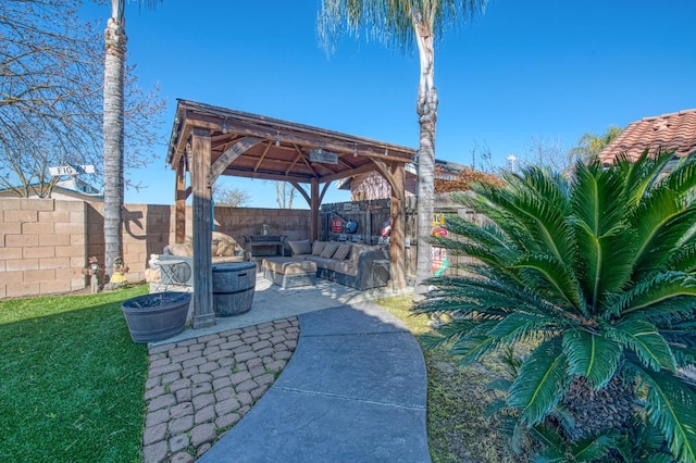 view of patio / terrace with an outdoor living space with a fire pit, a gazebo, and a fenced backyard