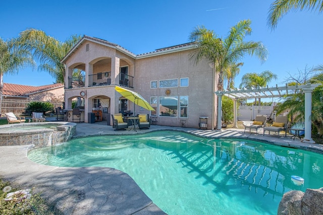 view of pool with fence, a patio area, a pergola, and a pool with connected hot tub