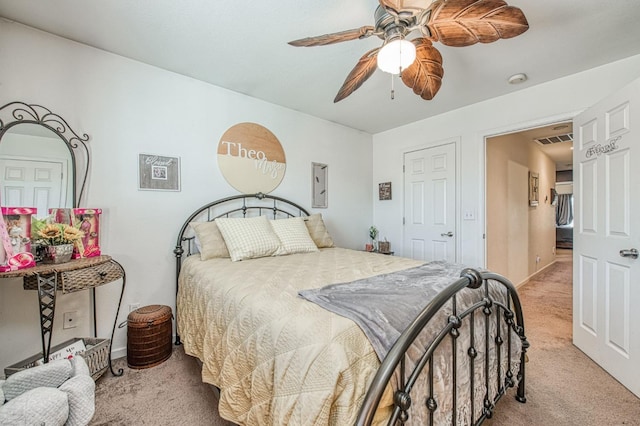 bedroom featuring visible vents, light colored carpet, and ceiling fan