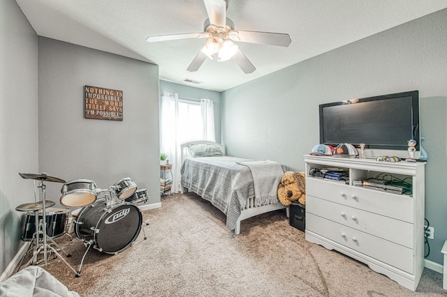 bedroom featuring visible vents, baseboards, carpet, and ceiling fan