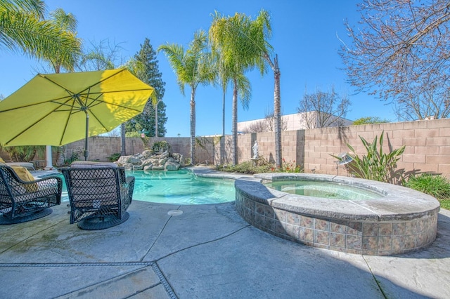 view of swimming pool with an in ground hot tub, a fenced backyard, a fenced in pool, and a patio