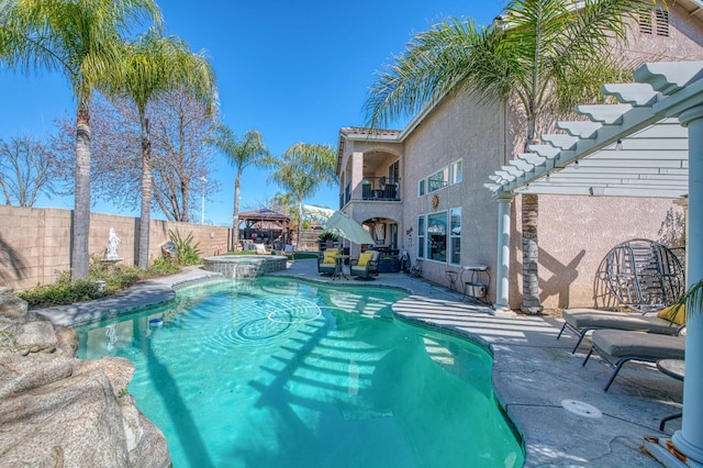 view of swimming pool featuring a gazebo, a patio area, a pool with connected hot tub, and a fenced backyard