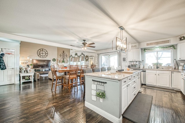 kitchen with white cabinets, a center island, a healthy amount of sunlight, and dark wood-style flooring