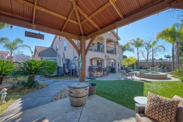 view of patio / terrace with a gazebo, a fenced in pool, a balcony, and fence