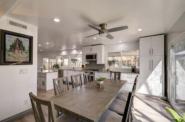 dining area featuring recessed lighting, visible vents, plenty of natural light, and a ceiling fan