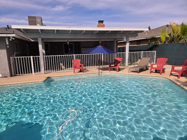 view of pool with a patio, a fenced in pool, and fence