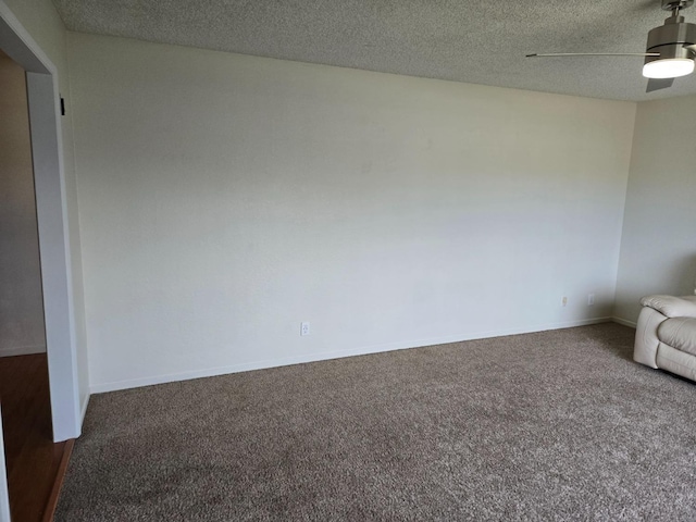 empty room featuring baseboards, a textured ceiling, ceiling fan, and carpet floors