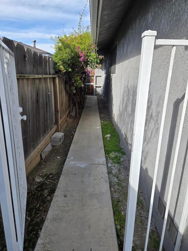 view of property exterior featuring fence and stucco siding