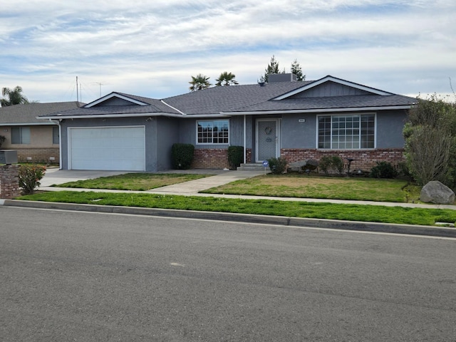 ranch-style home with brick siding, a front lawn, concrete driveway, and a garage