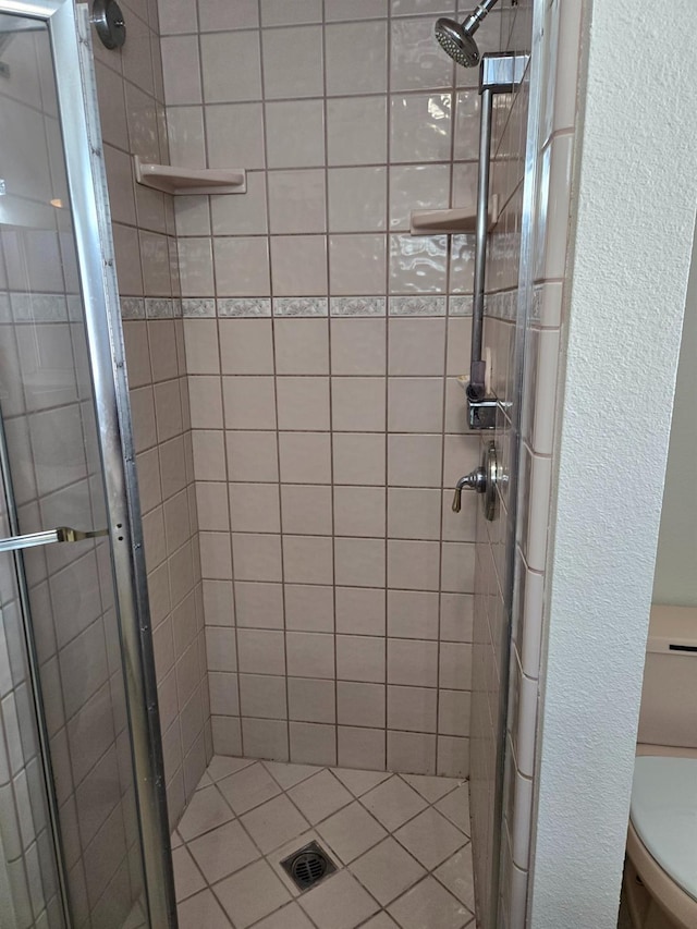 full bathroom with a shower stall and toilet