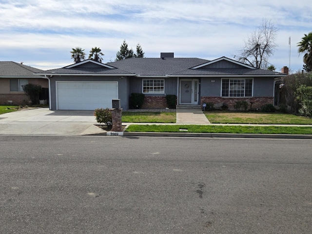 ranch-style home with a front lawn, brick siding, an attached garage, and driveway