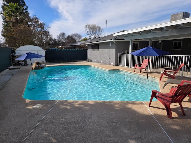 view of swimming pool with a patio, a fenced in pool, and fence