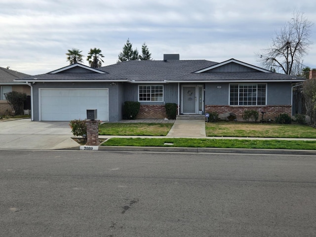 ranch-style home featuring brick siding, an attached garage, concrete driveway, and a front yard