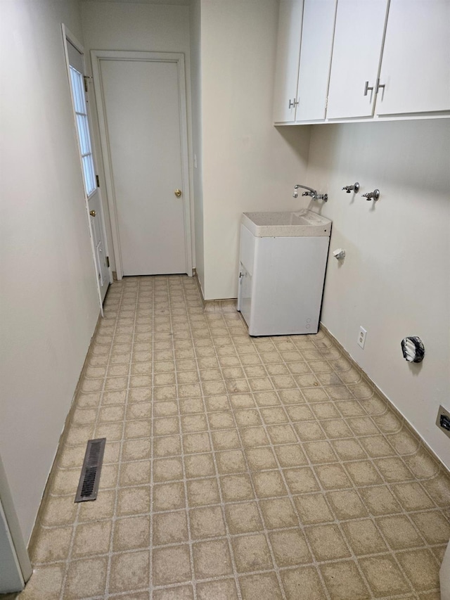 clothes washing area featuring a sink, visible vents, cabinet space, and hookup for a washing machine