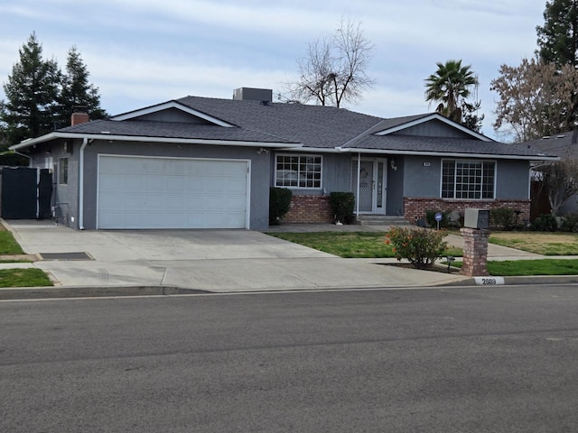 ranch-style house with brick siding, driveway, a chimney, and a garage