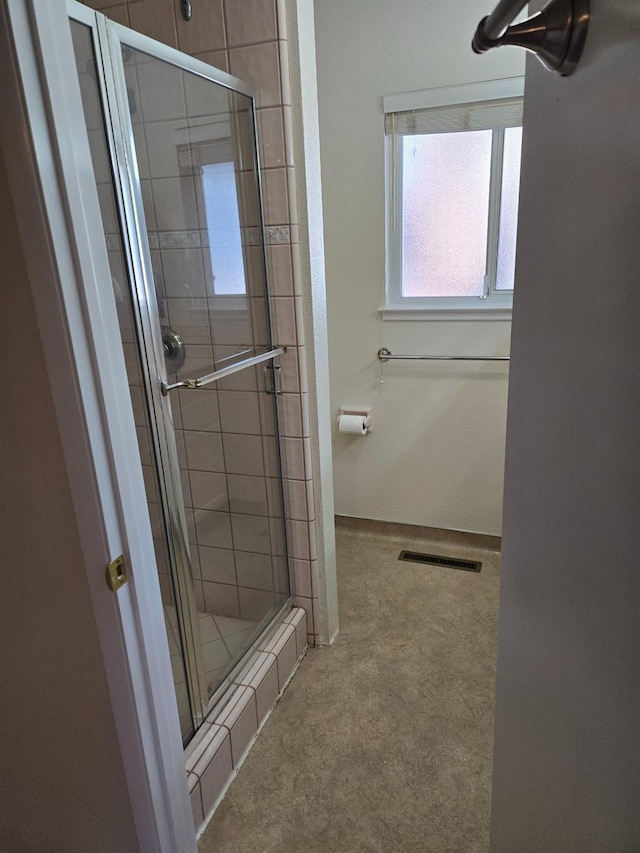 bathroom featuring visible vents, a stall shower, and baseboards